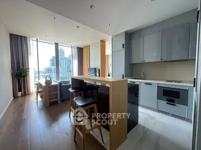 Modern open-plan kitchen and living area with city view and stylish furnishings.