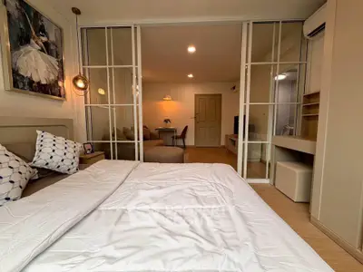 Modern bedroom with sliding glass doors and cozy decor