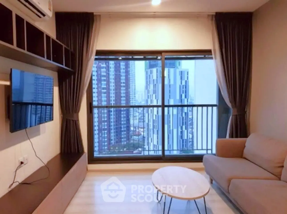 Modern living room with city view, featuring sleek furniture and large windows for natural light.