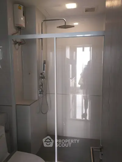 Modern bathroom with glass shower enclosure and sleek fixtures