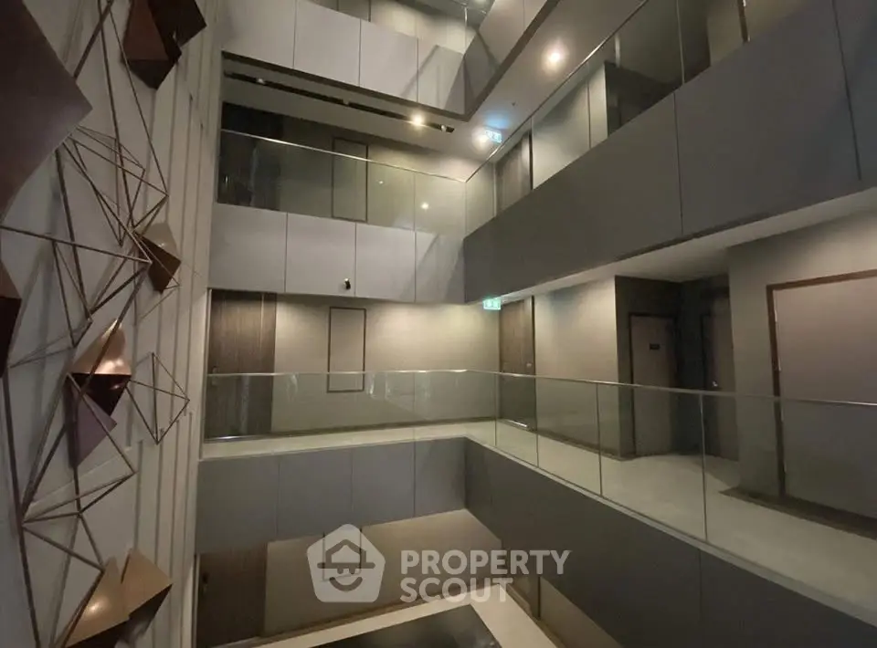 Modern apartment building interior with sleek design and geometric wall art