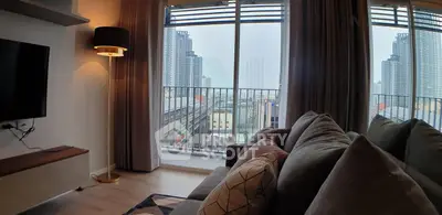 Modern living room with cozy sofa and city view from large windows