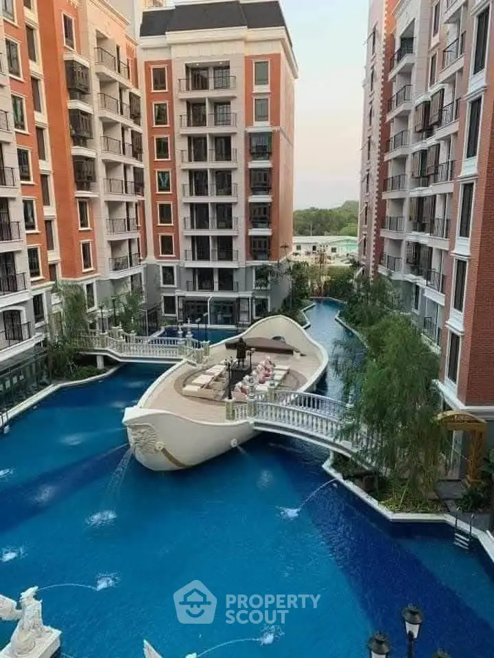 Luxurious apartment complex with unique boat-shaped pool and elegant architecture.
