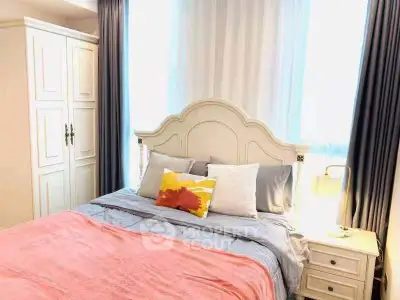 Charming bedroom with elegant decor and cozy ambiance, featuring a stylish bed and ample natural light.