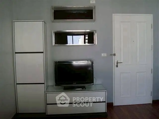 Modern living room with sleek TV stand and minimalist decor, perfect for contemporary urban living.