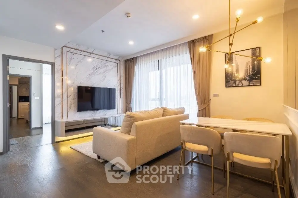 Modern living room with elegant decor and stylish lighting in a luxurious apartment.