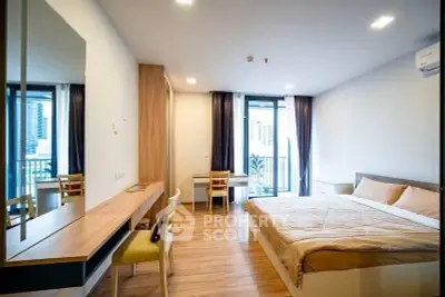 Modern bedroom with balcony view in urban apartment, featuring sleek wooden furniture and ample natural light.