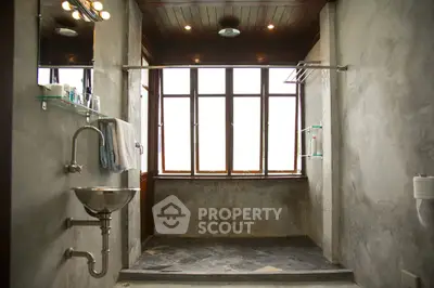 Spacious modern bathroom with large windows and industrial design