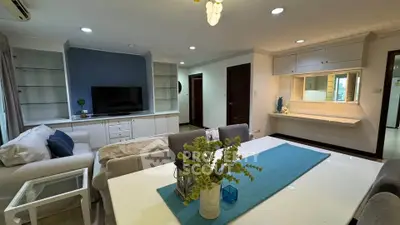 Spacious living room with modern decor and open layout, featuring a cozy seating area and stylish dining space.