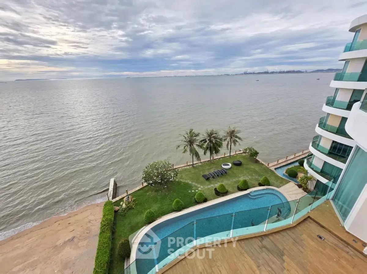 Stunning oceanfront view from luxury condo with pool and palm trees