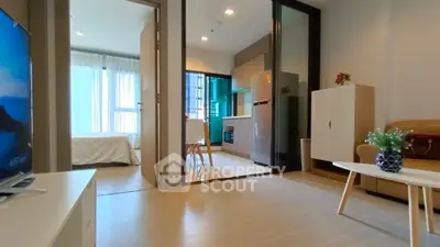 Modern open-plan living room with kitchen and bedroom view in stylish apartment