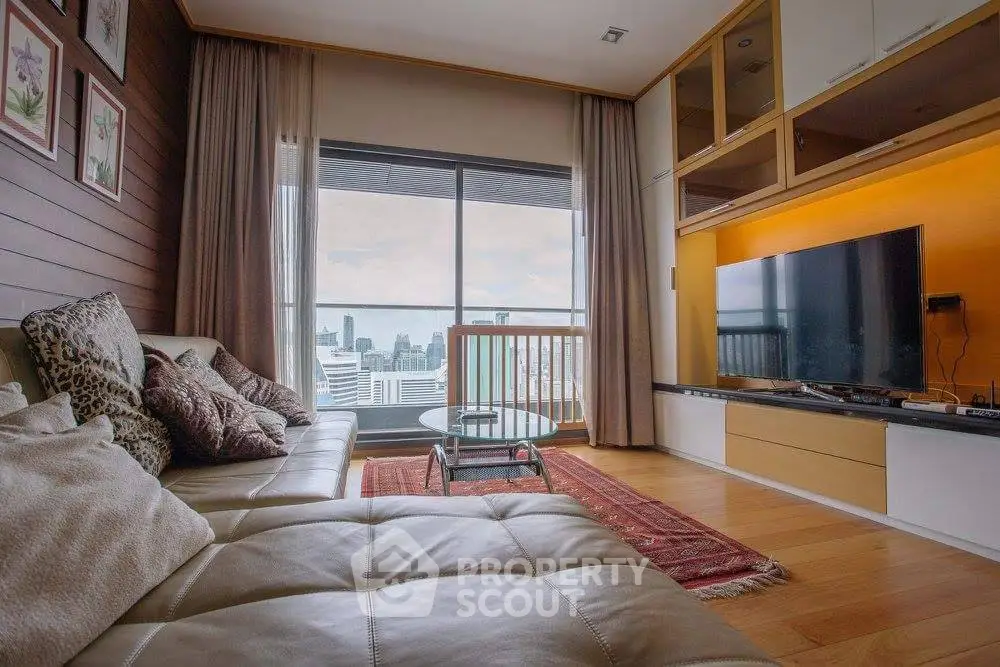 Luxurious living room with city view, modern decor, and large TV setup.