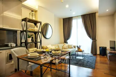 Modern living room with elegant decor and dining area in open layout apartment.