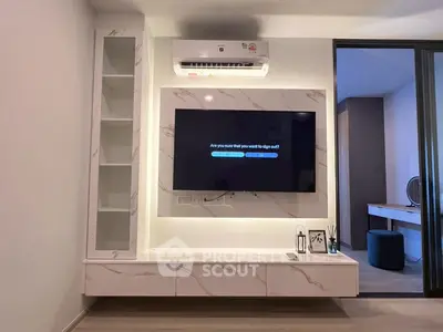 Modern living room with sleek TV setup and air conditioning