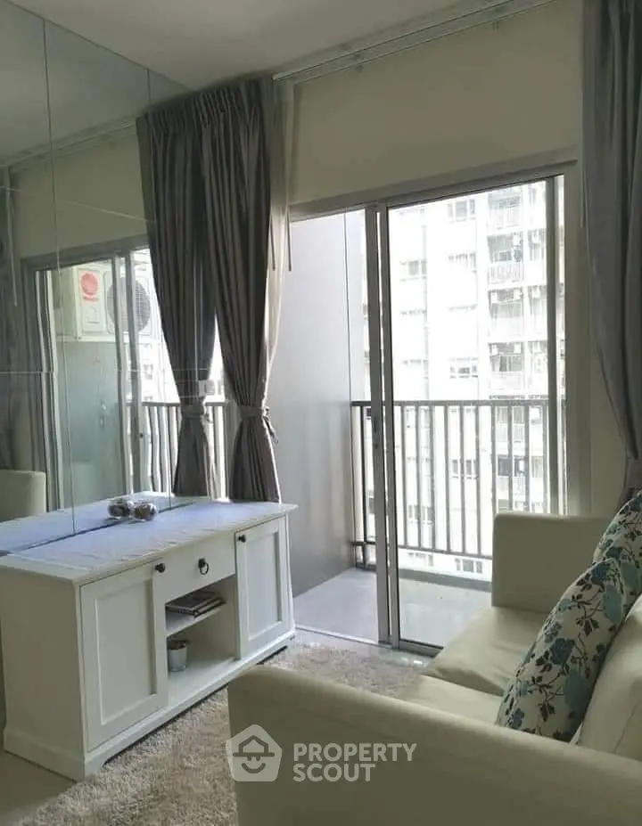 Chic living room with balcony access in modern apartment, featuring elegant decor and natural light.