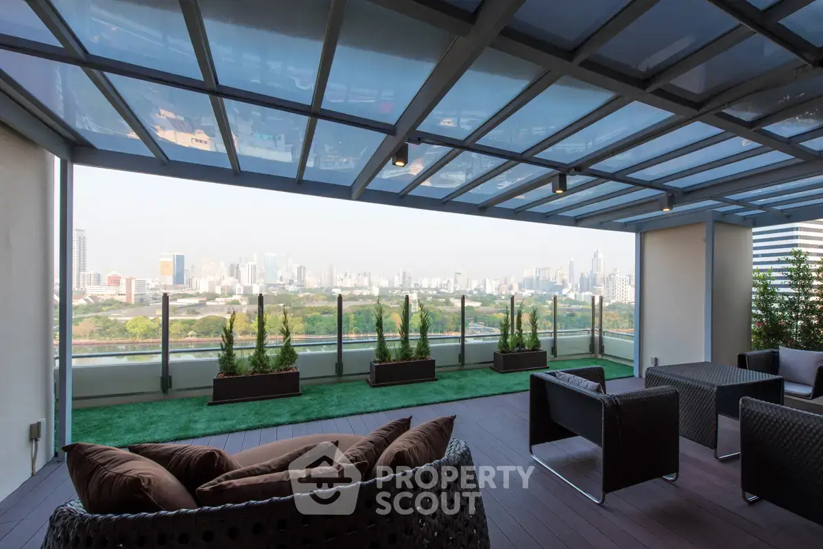 Luxurious rooftop terrace with stunning city skyline view and modern outdoor seating.