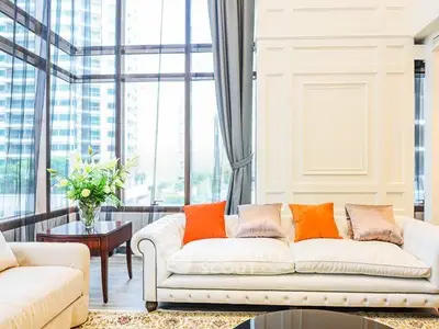 Luxurious living room with floor-to-ceiling windows and elegant decor