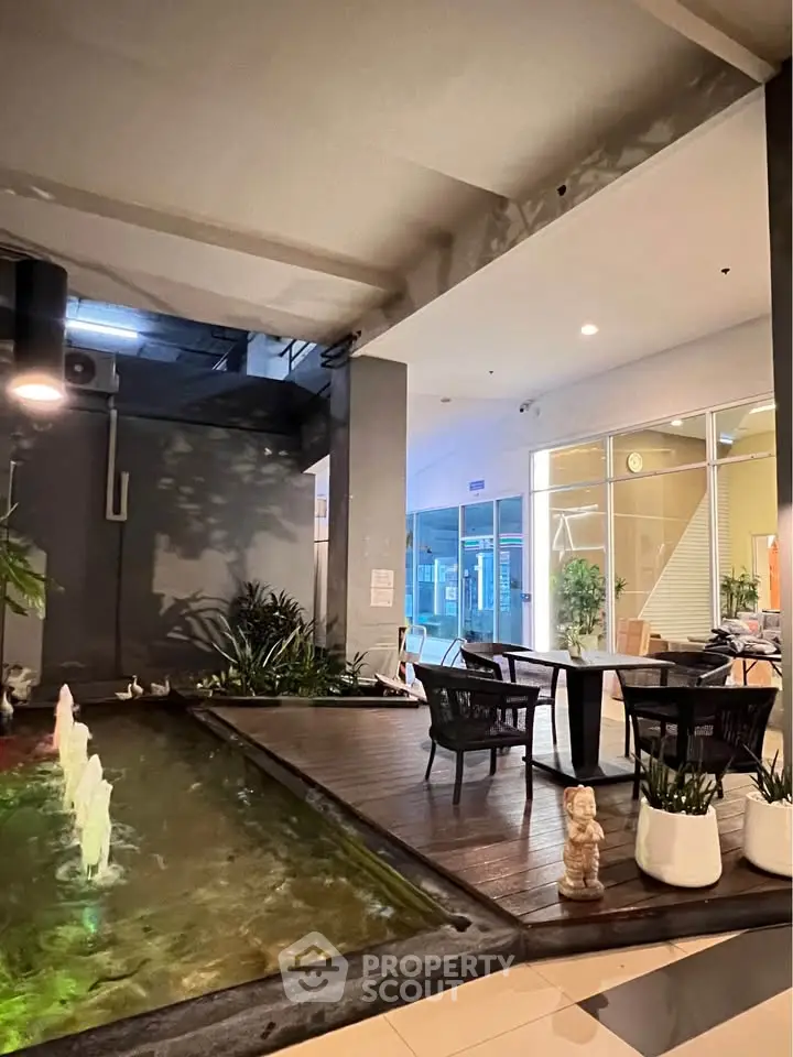 Elegant indoor seating area with water feature in modern building lobby