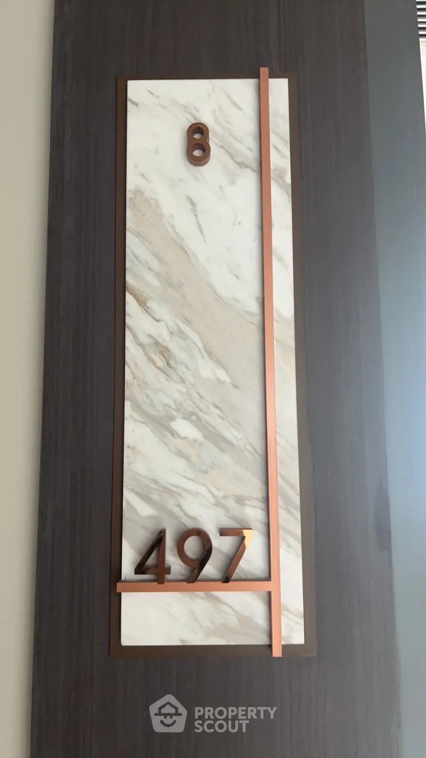 Elegant marble and wood apartment number plaque with modern design