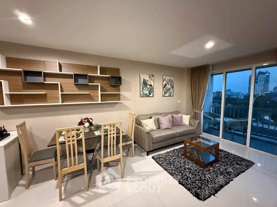 Modern living room with stylish decor and city view balcony