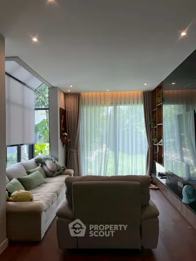Cozy living room with large windows and modern decor