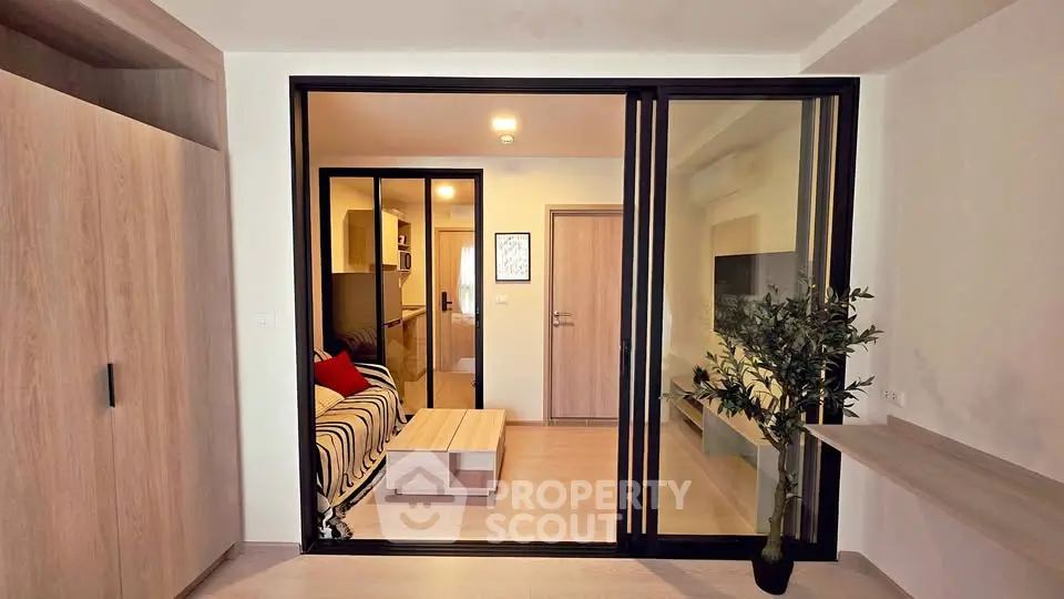 Modern apartment interior with sliding glass doors and cozy living area