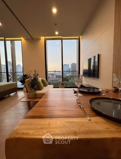 Luxurious living room with stunning city view, elegant decor, and modern furnishings in a high-rise apartment.