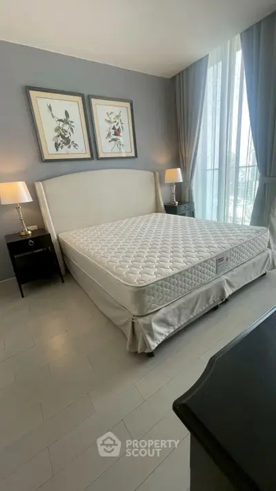 Elegant bedroom with modern decor and large windows for natural light.