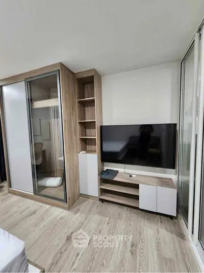 Modern bedroom with sleek TV unit and built-in wardrobe