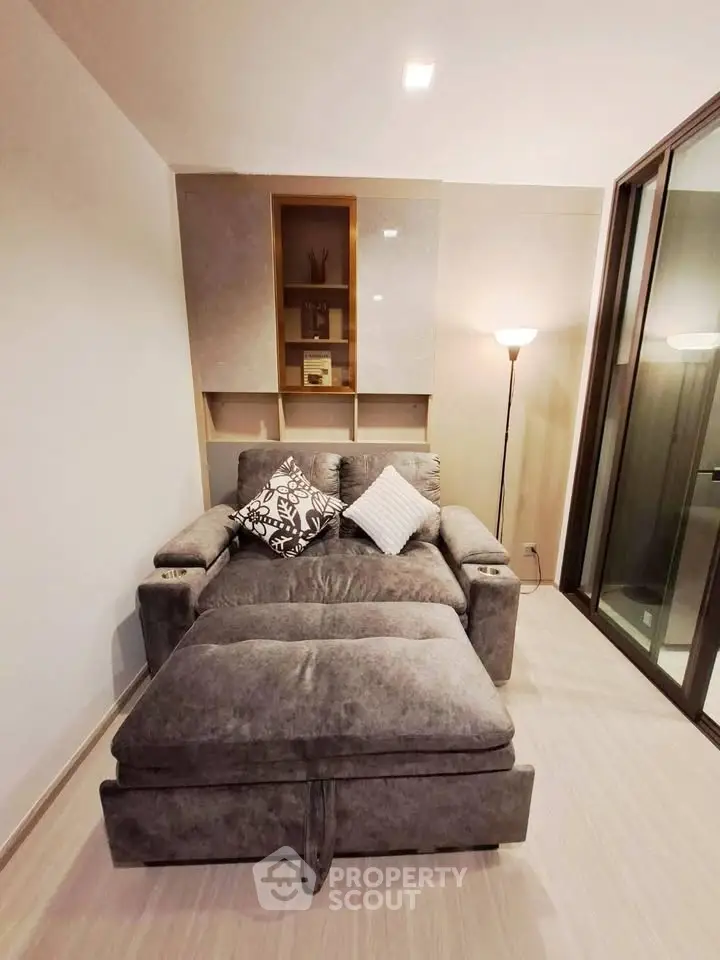 Cozy living room with plush gray sofa and modern floor lamp