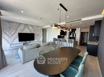 Spacious modern living room with open kitchen and stylish dining area, perfect for entertaining.