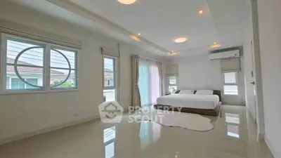 Spacious modern bedroom with large windows and elegant decor