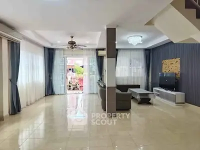 Spacious living room with modern decor and large windows for natural light.