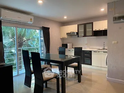 Modern open-layout kitchen and dining area with sleek furniture and natural light.