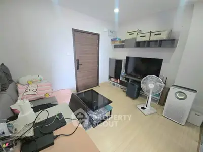 Cozy living room with modern decor, featuring a TV, air purifier, and stylish shelving.