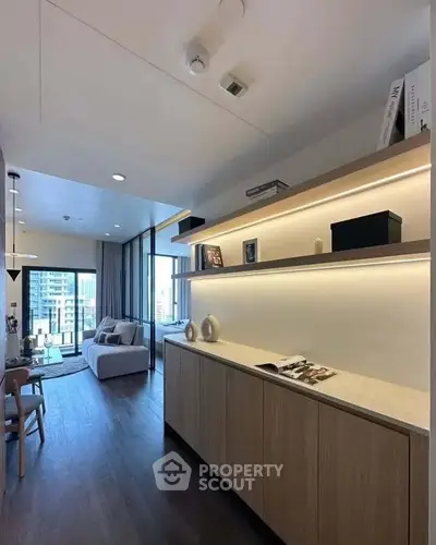 Modern living room with sleek design and city view, featuring elegant shelving and cozy seating area.