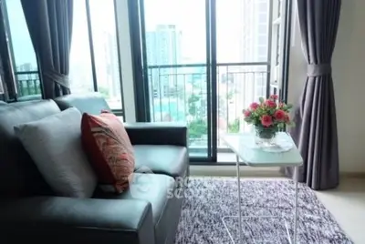 Stylish living room with city view, featuring modern sofa and elegant decor.
