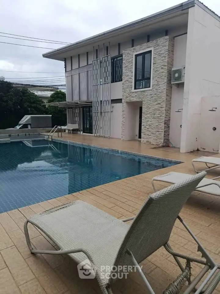 Luxurious modern house with private pool and stylish outdoor lounge area.