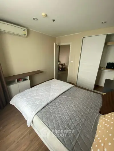 Cozy bedroom with modern decor and air conditioning in a stylish apartment.