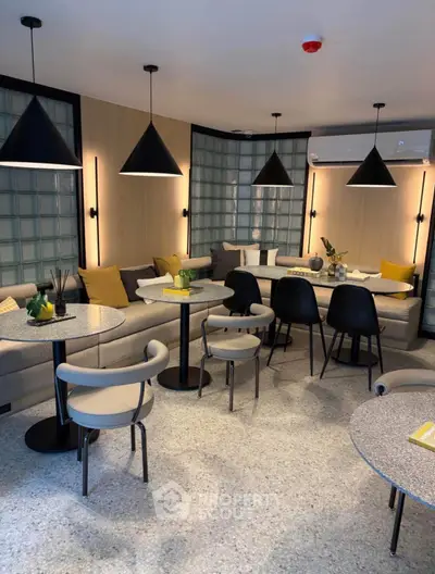 Modern living room with stylish furniture and ambient lighting, perfect for relaxation and social gatherings.