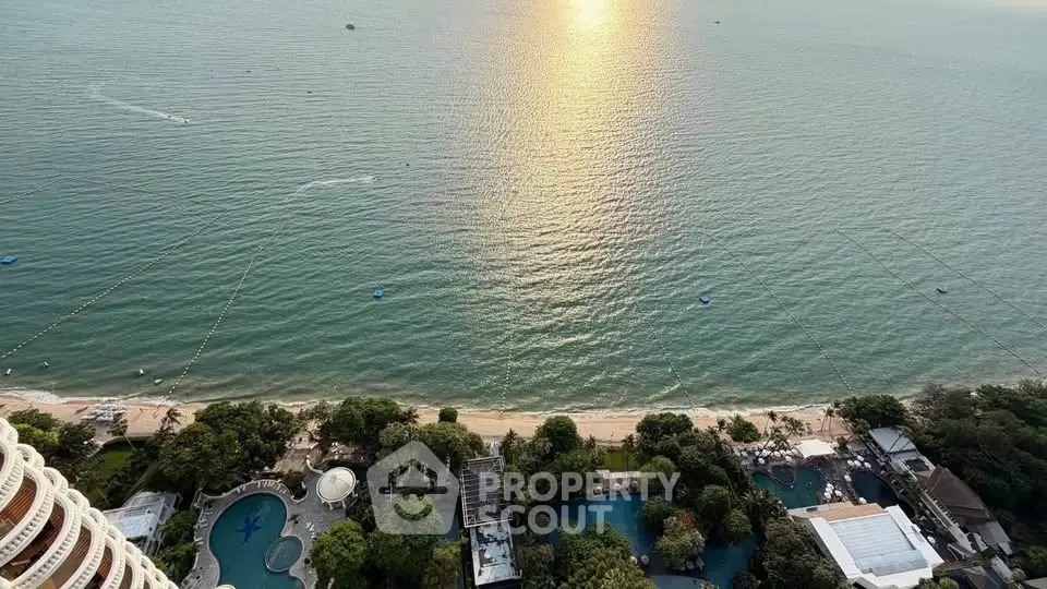 Stunning ocean view from high-rise building with pool and lush greenery