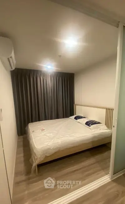 Cozy bedroom with modern design and ambient lighting, featuring a comfortable bed and elegant curtains.