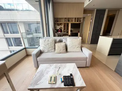 Modern living room with large windows and cozy sofa in a stylish apartment
