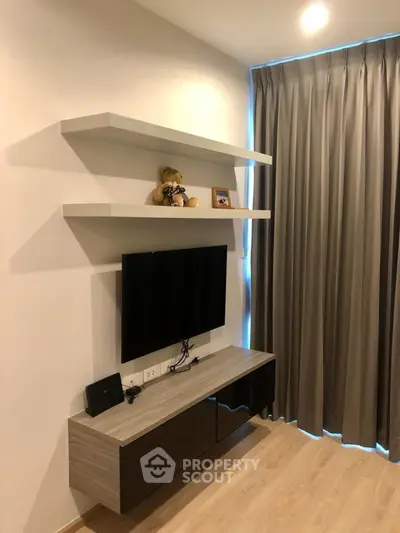 Modern living room with sleek TV setup and stylish shelving