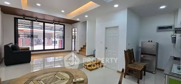 Spacious modern living room with stylish furniture and large windows for natural light.