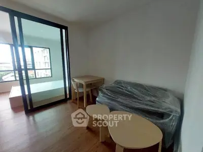 Modern apartment interior with wooden flooring and minimalist furniture