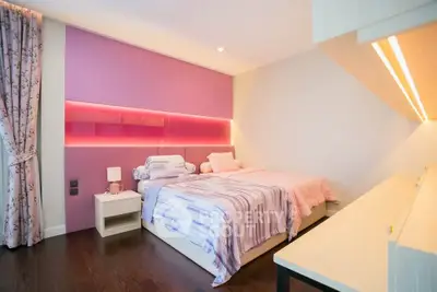 Chic modern bedroom with stylish pink accents and cozy ambiance