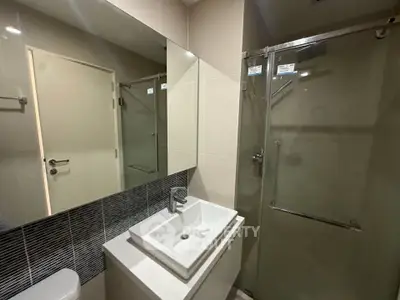 Modern bathroom with sleek fixtures and glass shower enclosure