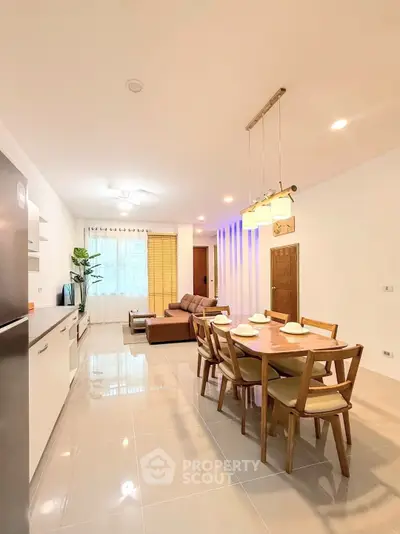 Spacious open-plan living and dining area with modern furnishings and natural light.