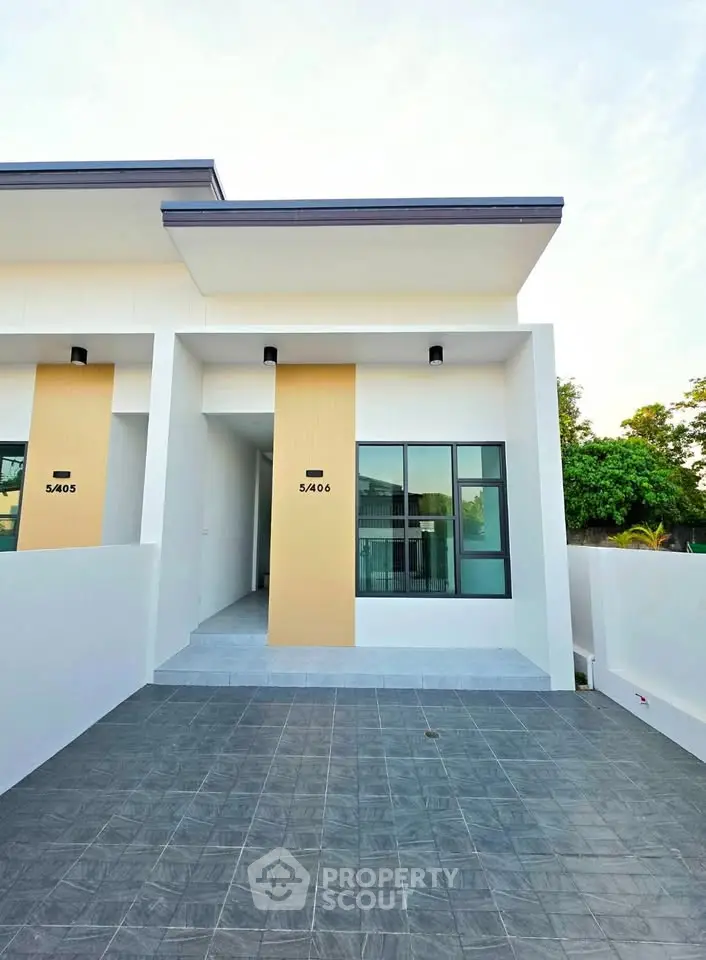 Modern townhouse exterior with sleek design and spacious driveway